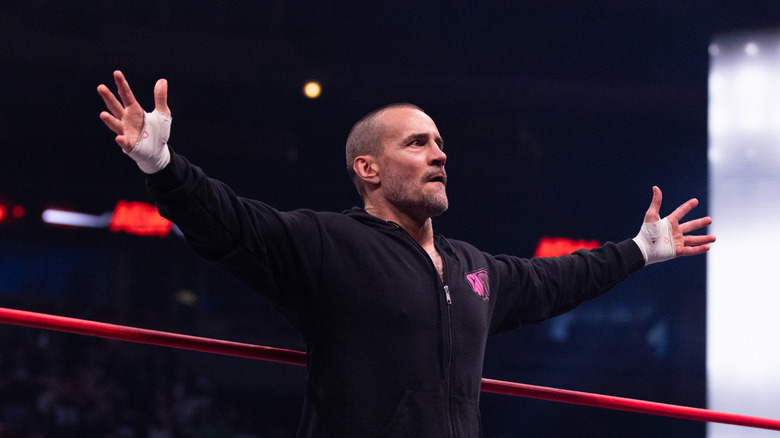 CM Punk posing on the ring apron on "AEW Collision"