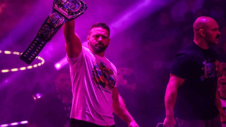 FTR walking to the ring surrounded by purple lights
