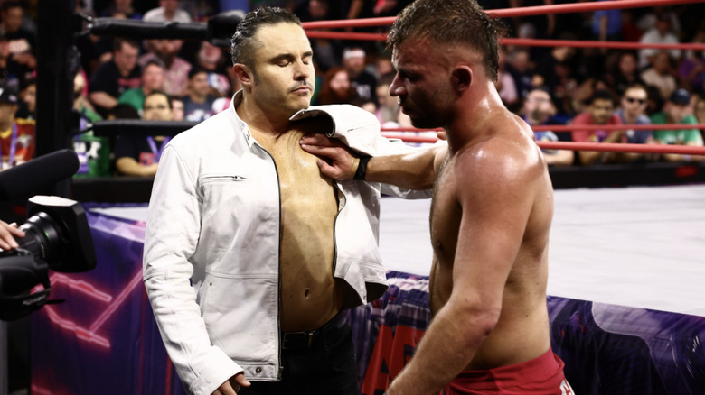 Garcia and Daddy Magic on the outside of the ring.