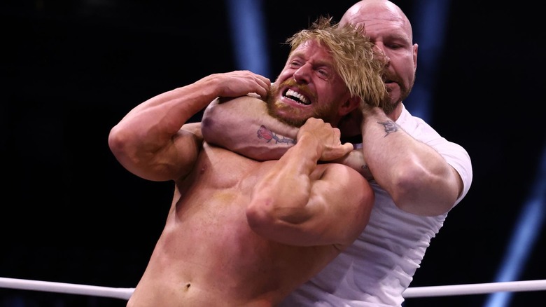 Jon Moxley puts Orange Cassidy in a headlock
