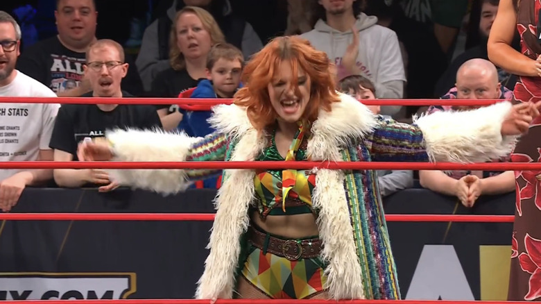 Jamie Hayter makes her entrance with a wide smile.