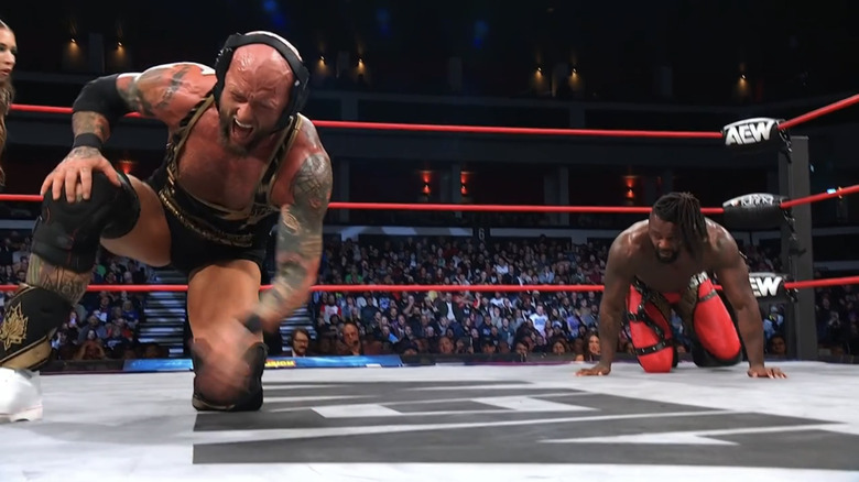 Josh Alexander's knee is hurting as Swerve Strickland prowls on him from the corner.