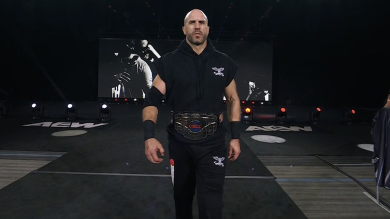 Claudio Castagnoli walks menacingly down the entrance ramp with the CMLL World Heavyweight Title around his waist.
