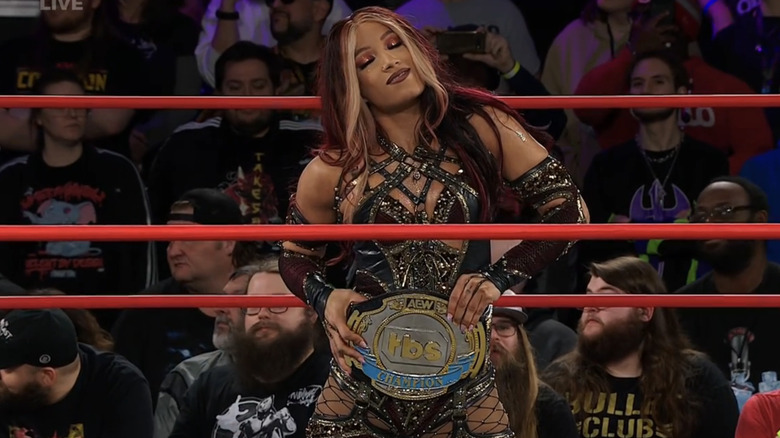 Mercedes Mone poses confidently and comfortably with her AEW TBS championship.
