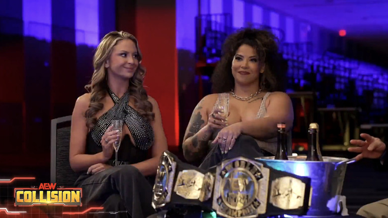 Harley Cameron and Willow Nightingale smile as they hold flutes of champagne.