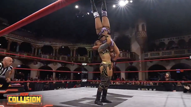 Statlander about to hit a delayed vertical suplex on Kross