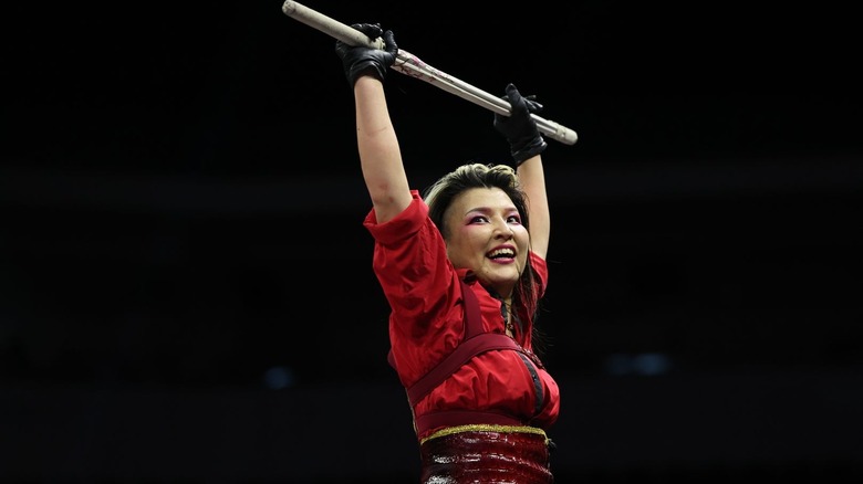 Hikaru Shida poses with a kendo stick