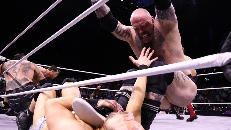 Butcher stepping on Adam Cole's neck in a battle royal