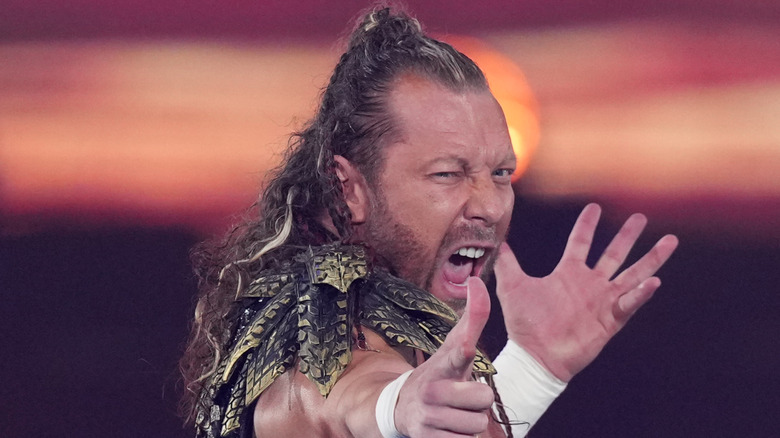 Kenny Omega does his trademark pose