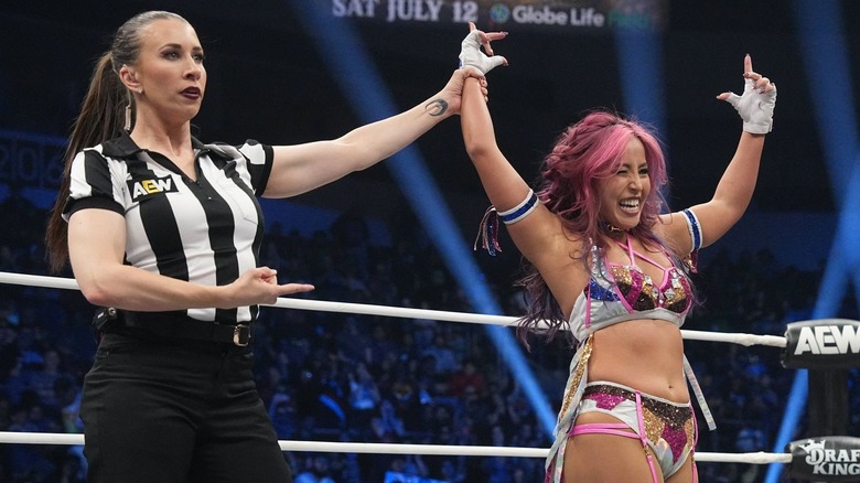 Referee Aubrey Edwards holds up Mina Shirakawa's hand.
