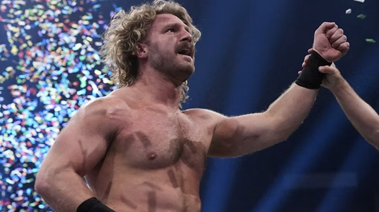 Adam Page gets his hand raised while confetti goes off behind him at AEW Double or Nothing