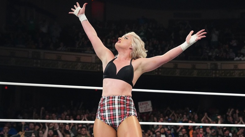 Toni Storm raises her arms