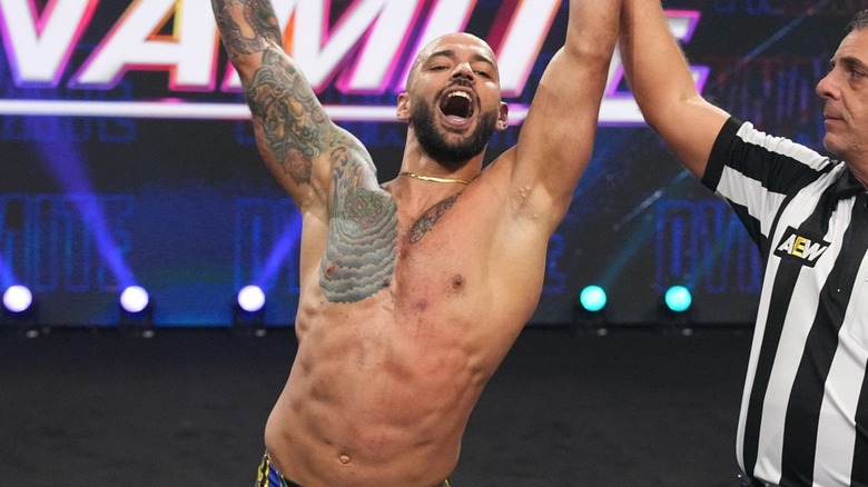 Ricochet raising his arms in victory