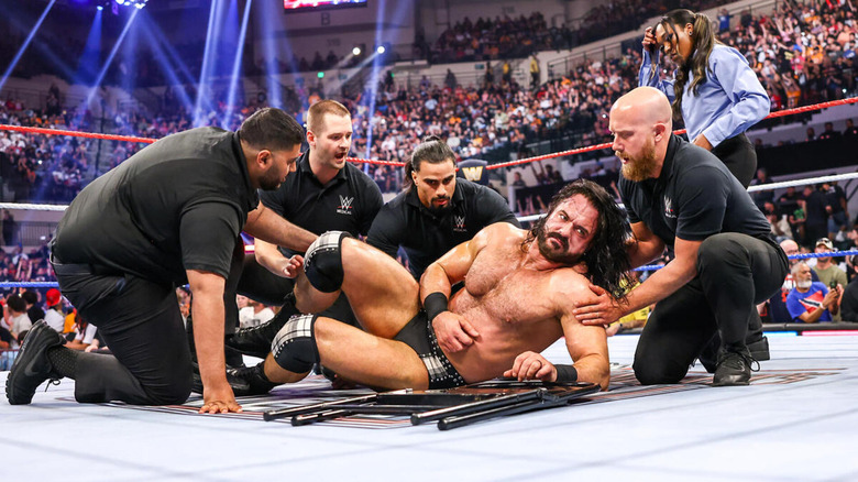 Drew McIntyre is tended to by medical personnel in the center of the ring.