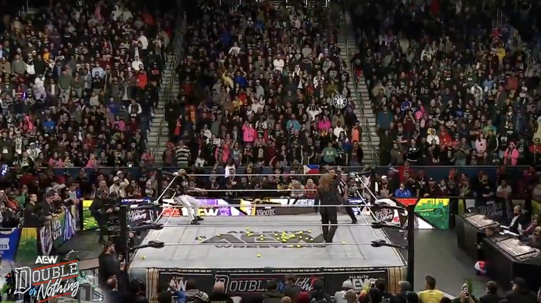 Ricochet and Jericho in the ring with several tennis balls