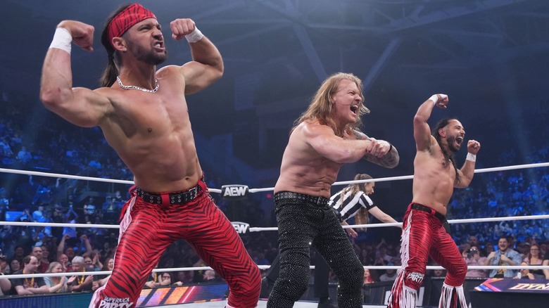 The Young Bucks and Chris Jericho flexing their arms