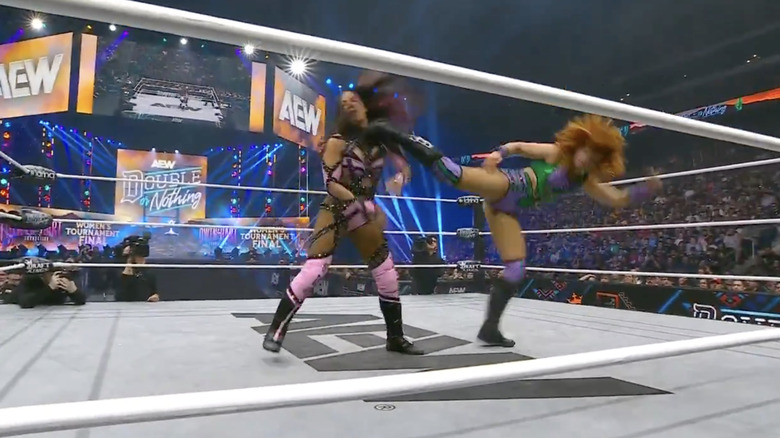 Hayter landing a superkick on Mone