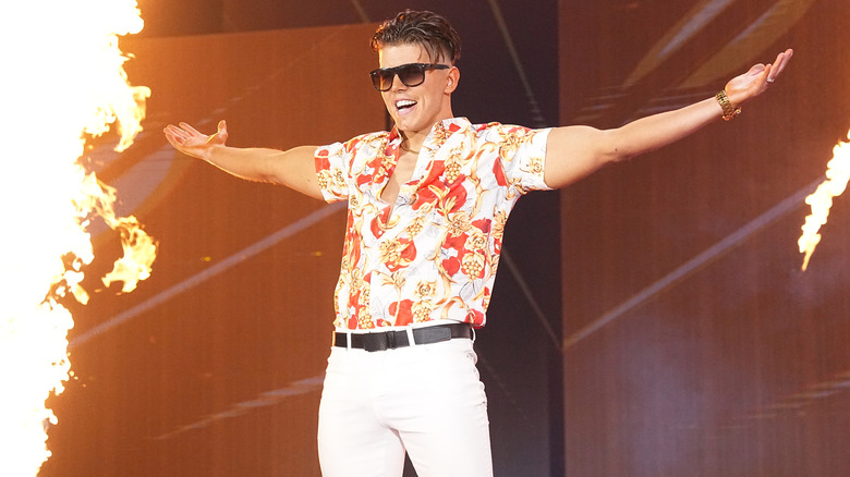 Fire goes off around Sammy Guevara as he spreads his arms wide