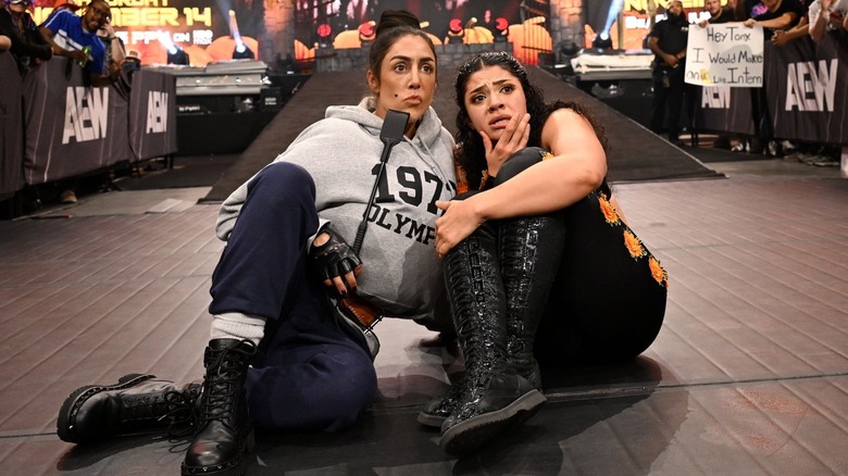Britt Baker dressed up as Miss Trunchbull sits outside the ring with Persephone on "AEW Dynamite"