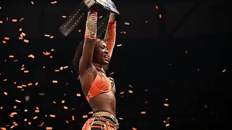 Queen Aminata holds the TBS title high as confetti swirls around her on "AEW Dynamite"