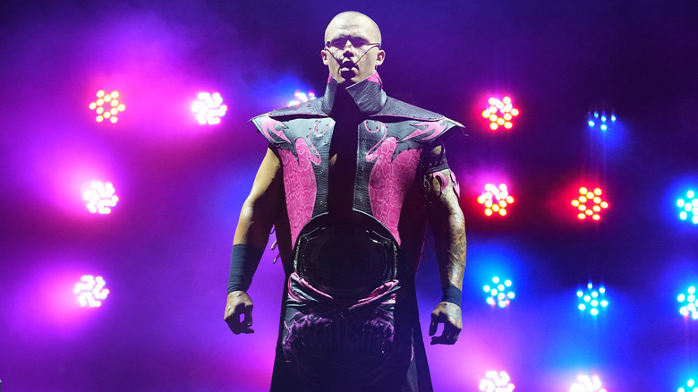 Kyle Fletcher stands on stage as the lights come up during his entrance ahead of his match at AEW WrestleDream.
