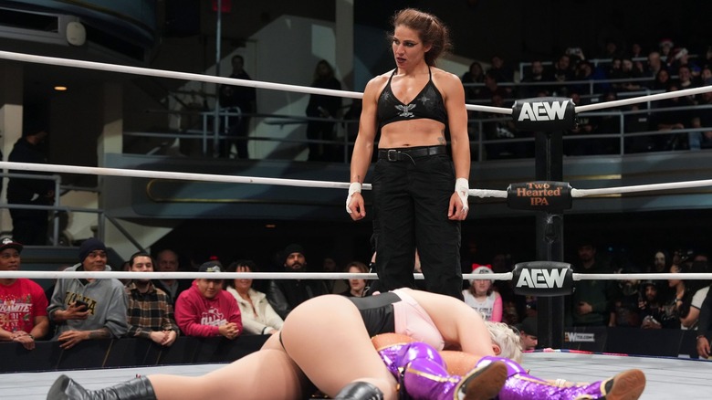 Marina Shafir stands over two fallen bodies