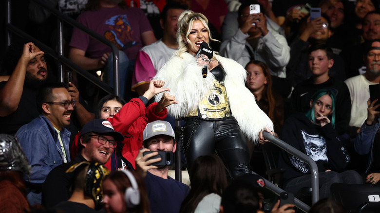 AEW Women's World Champion Thekla cuts a promo in the crowd, directed toward Thunder Rosa in the ring, during an episode of "AEW Dynamite."