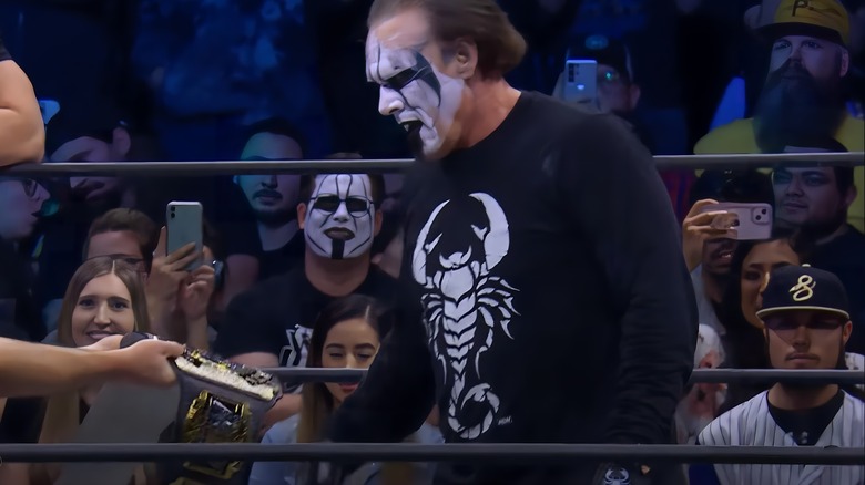 Sting is handed a title belt
