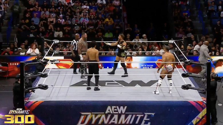 The four men inside the ring as MJF offers King a wad of cash
