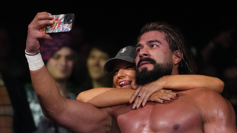 Andrade takes a selfie with a fan
