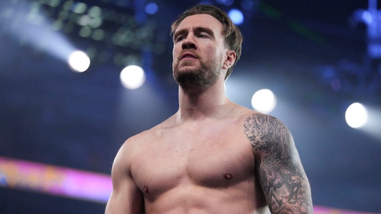 Will Ospreay stands in the ring