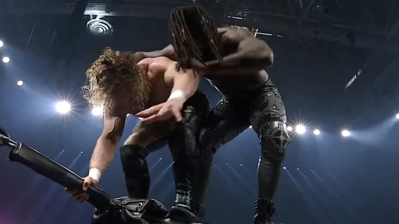 Omega and Strickland on the top rope