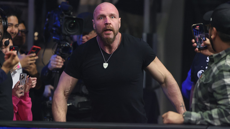 AEW World Champion Jon Moxley stands shocked at the ring barricade by what he's seeing Cope doing in the ring during an episode of "AEW Dynamite."