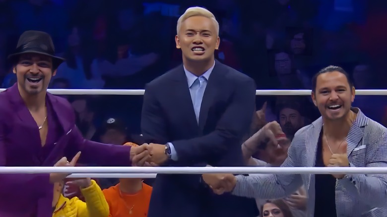 Kazuchika Okada shakes hands with the Young Bucks