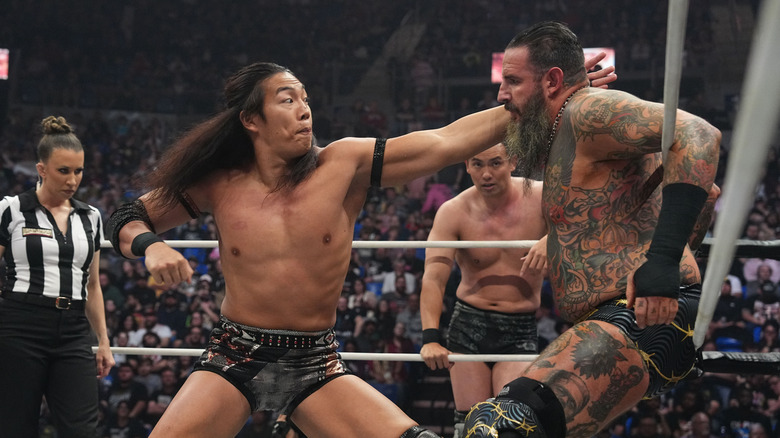 Konosuke Takeshita looks to deliver a punch to Brody King, as Kazuchika Okada looks on from the corner, at AEW WrestleDream 2025.