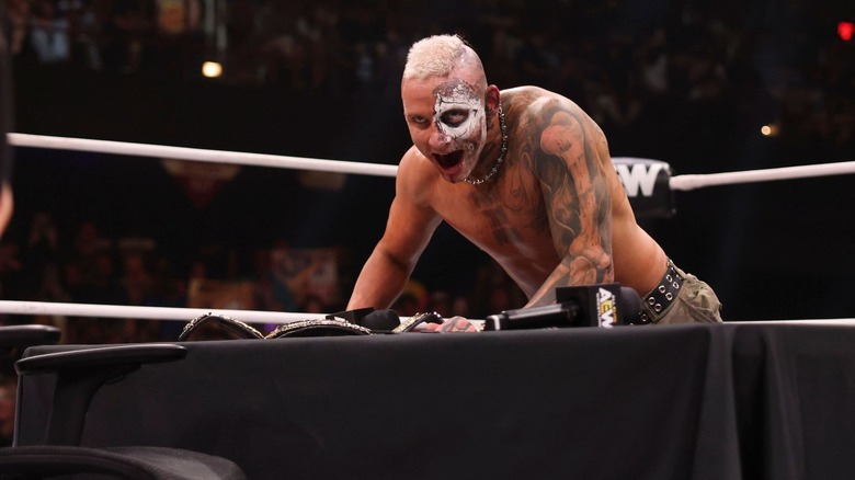 Darby Allin glowers over the contract signing table