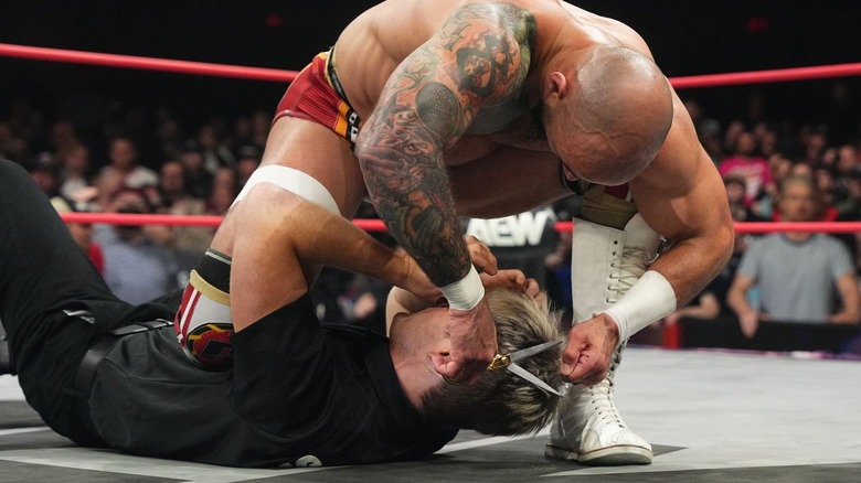 Ricochet cutting Zach Gowen's hair with scissors on "AEW Collision"