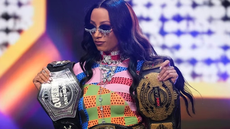 Mercedes Mone holding her championship belts on "AEW Dynamite"
