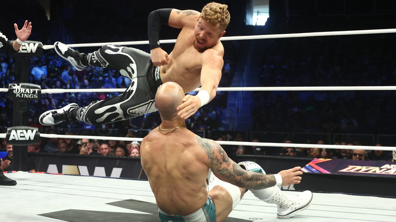 Blake Christian hitting a diving elbow on Ricochet on "AEW Dynamite"