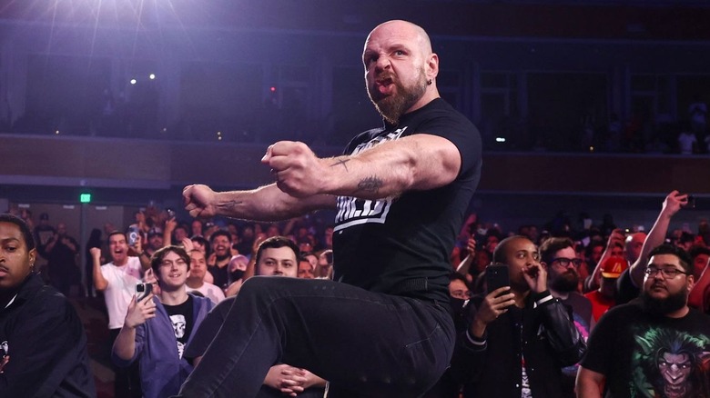 Jon Moxley pumps his arms as he makes an entrance