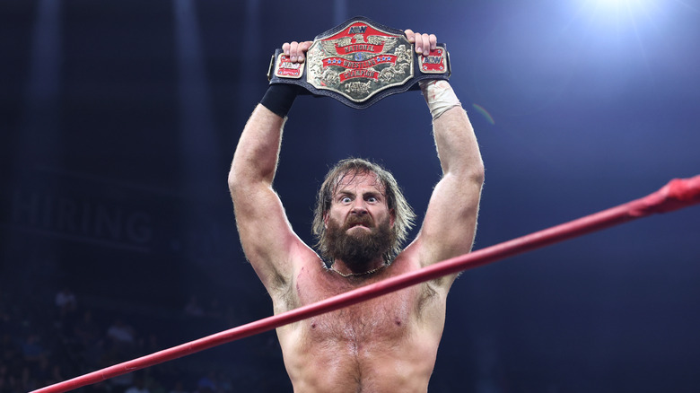 Mark Davis hoists the AEW National Championship high following a victory on a July 2026 edition of "AEW Dynamite."