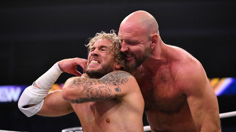 Jon Moxley grimaces behind Will Ospreay