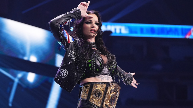 Saraya making an L on her forehead