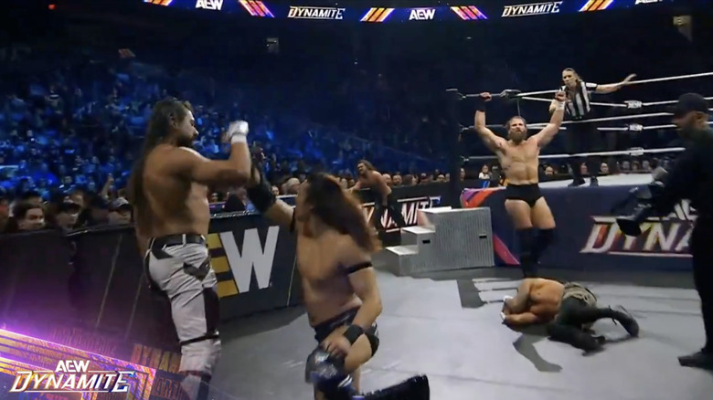 The Don Callis Family standing over Allin at the bottom of the entrance ramp