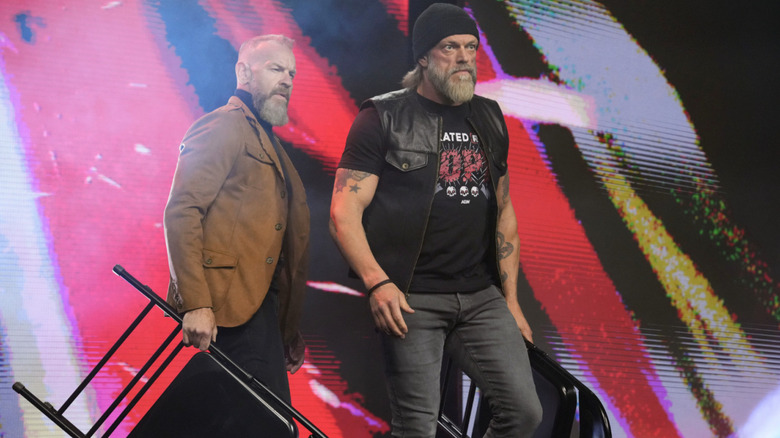 Copeland and Cage with chairs in hand