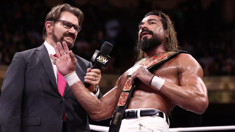 Andrade in the ring with Tony Schiavone