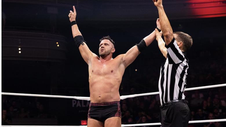 A referee raising McGuinness' arm
