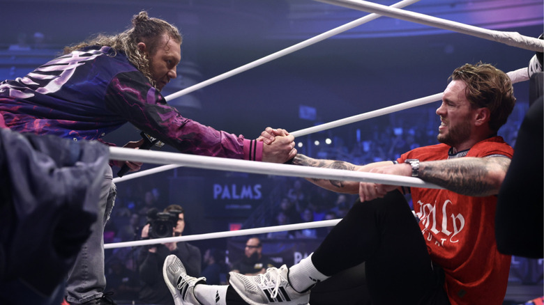Omega helping up Ospreay