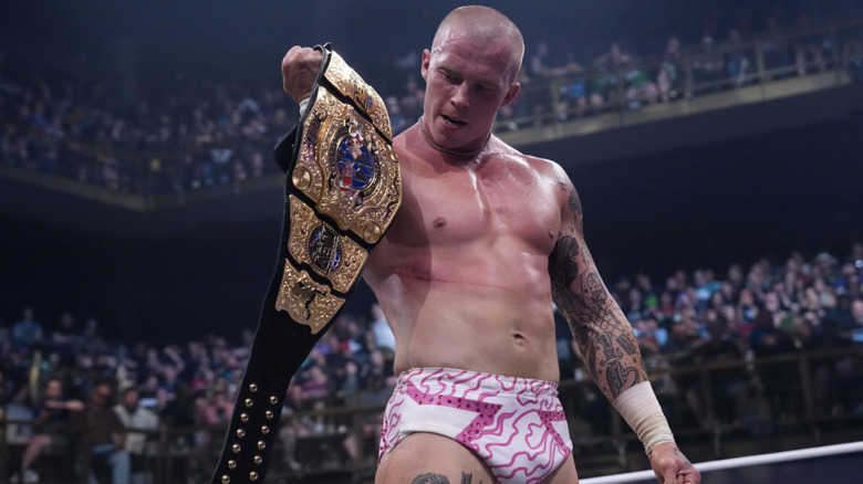 Fletcher holding up his International Championship belt