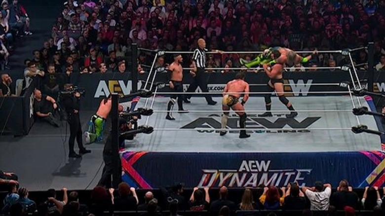 The Don Callis Family wrestle Adam Copeland in the ring